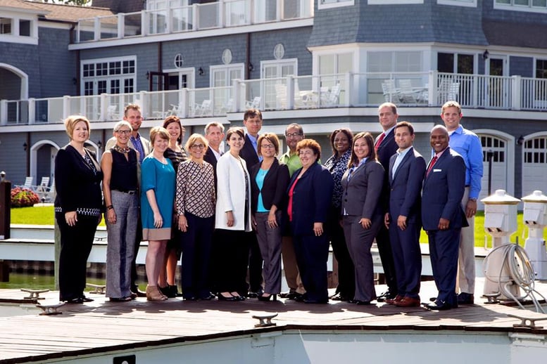 Participants of professional networking organization pose at event space